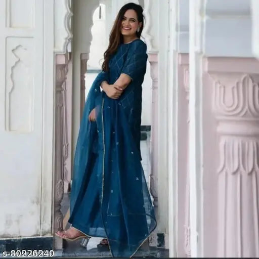 Gold-printed rayon kurta set with chiffon sharara dupatta and bottomwear, three-quarter sleeves. Indian women's fashion attire on mannequin