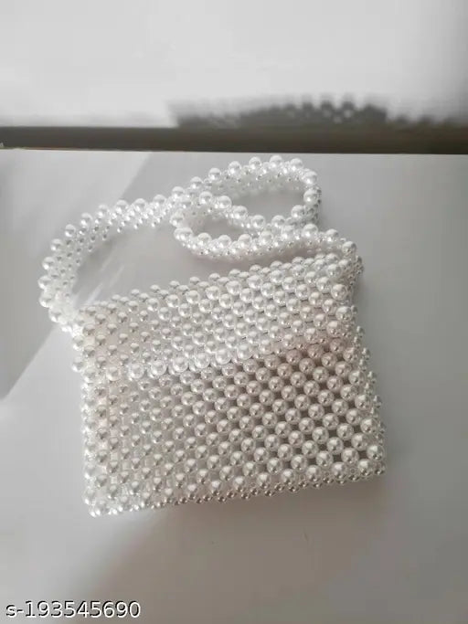 High quality white plastic pearl shoulder/crossbody bag with embellished net pattern, perfect for women's daily use or travel. Elegant and unique design, free size (4in L x 7in W), handmade in India. May have slight color variation due to camera lens and light environment