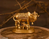 Handmade brass Kamdhenu Nandi cow statue with golden finish, symbolizing prosperity and Vatsalya (motherly love)