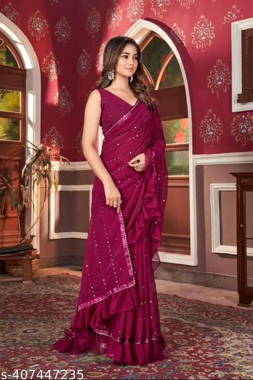 Embellished pink poly-georgette saree with solid border, perfect for special functions and featuring ruffles for a feminine, timeless look