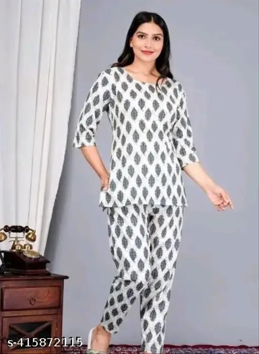 Black cotton printed night suit top and pyjama coord set for women, featuring three-quarter sleeves and stylish print design. Made from soft cotton fabric for comfort. Available in sizes S, M, L, XL, XXL, XXXL. Co-ord sets ideal for daily, casual, formal, and party wear. Origin: India