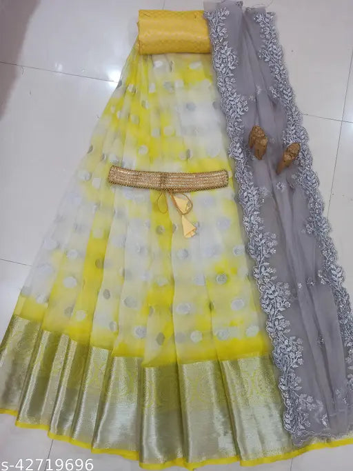 Trendy South Indian style yellow organza lehenga, choli & dupatta set (un-stitched). Embroidered, soft silk top, organza bottom, net dupatta in unstitched sizes with belt included. Indian-made traditional wear on display