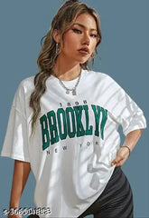White cotton printed oversize Brooklyn t-shirt with off-shoulder design for women, featuring a trendy motif on a short sleeve. XS (36in bust, 25in length), S (38in bust, 26in length), M (40in bust, 27in length), L (42in bust, 28in length), XL (44in bust, 29in length) also available in black
