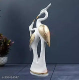 High-quality resin Love Swan Pair decorative statue, big size (13cm x 36cm), ideal for home living room or bedroom. Symbolizes love and peace in Feng Shui. Perfect gift for couples, newlyweds, or loved ones. Durable polyresin construction with weather resistance. Clean with dry or moist cloth. Made in India