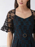 Black polyester self-design v-neck jumpsuit with short sleeves, featuring frilled sheer raglan sleeves, contrast lace detailing, and buckled waistband. Includes two side pockets, available in sizes XS - XL. Solid black and teal design, made in India