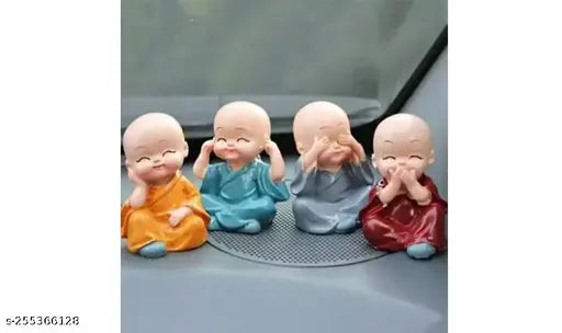 Four small, intricate poly resin Buddha statues, each depicting a baby monk, ideal for car decor. Indian-crafted Monk Little Baby Buddha set
