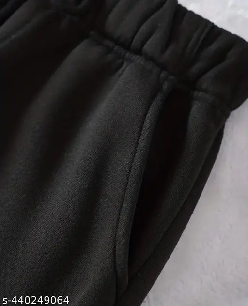 Black polycotton women's joggers with elastic waistband, deep side pockets. Ideal for sports, gym, or running. Comfortable wear for winters