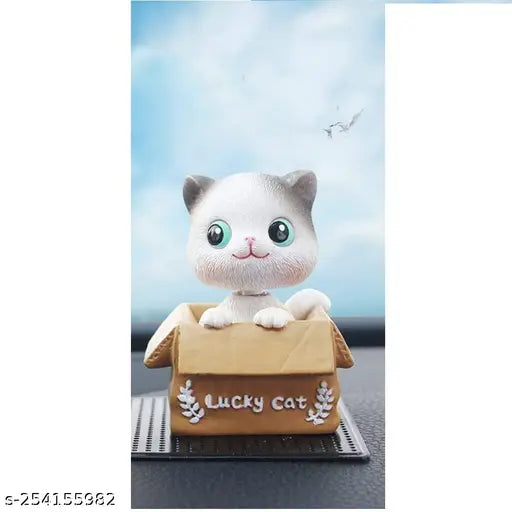 Resin resilient cat bobble head toy, shaking head, auto interior decoration, home office desktop décor. Environmentally friendly and durable with self-adhesive for easy installation. Cute cartoon design perfect for ladies and girls. Suitable for various locations and occasions as a gift