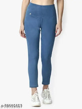 Blue denim jeggings or jeans, solid-colored denim for women's casual wear on model