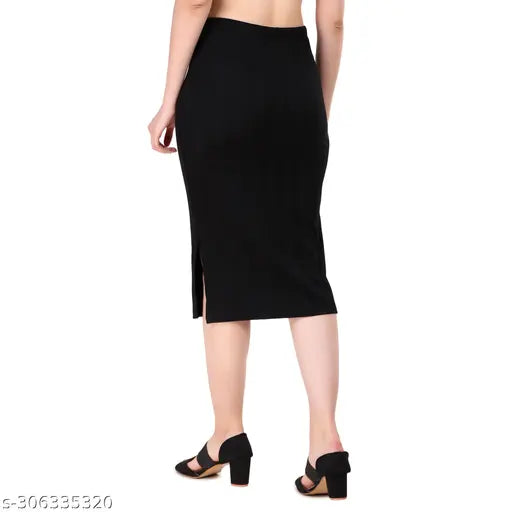 Black ribbed pencil skirt with elastic waistband, side slit and calf length for women's partywear. Made from cotton knit. Machine washable. Available sizes: 26 (Waist 26in, Length 28in), 28 (Waist 28in, Length 28in), 30 (Waist 30in, Length 29in), 32 (Waist 32in, Length 29in), 34 (Waist 34in, Length 29in). Origin: India