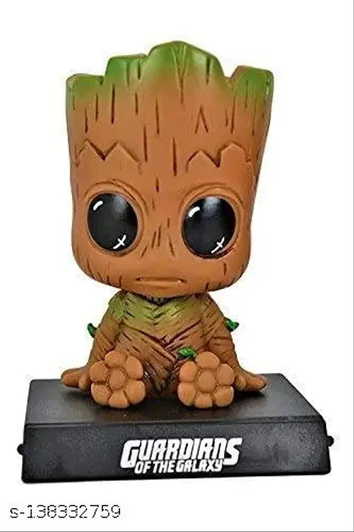 Green Groot bobblehead figurine with stand on tabletop