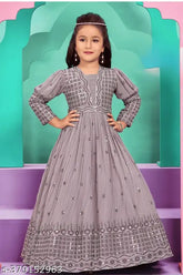 Light purple ethnic gown, embroidered net, three-quarter sleeves. Traditional Indian design for girls' special occasions." (96 characters)
