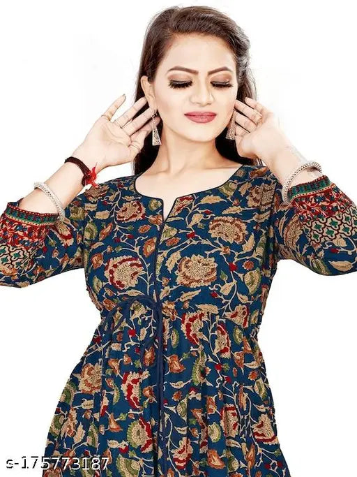 Blue printed long Anarkali gown, rayon, three-quarter sleeves. Woman wearing vibrant all-over print dress in casual setting