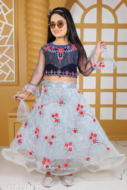 Velvet lehenga and net choli with zari stitch for girls, available in sizes 4-5 years to 8-9 years. Indian traditional attire on display