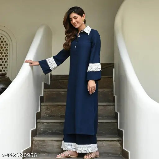 Navy blue rayon Pakistani-style kurta with palazzos set, intricate lacework on collar, sleeves, and pant ends, long sleeves, straight cut