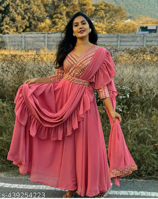Pink georgette Indo-Western Anarkali gown with ruffled dupatta, intricate embroidery, and three-quarter sleeves. Ideal for festive occasions and weddings. Available in sizes S to XXXL, made in India