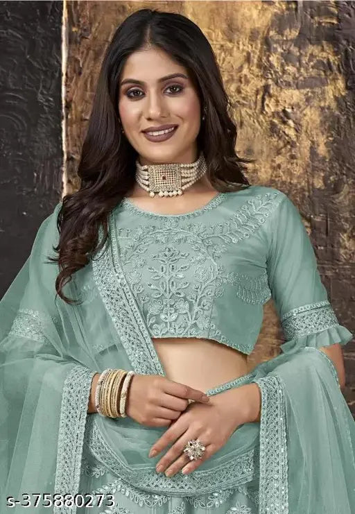 Mint green embroidered lehenga choli set on mannequin, semi-stitched Indian net fabric for traditional events