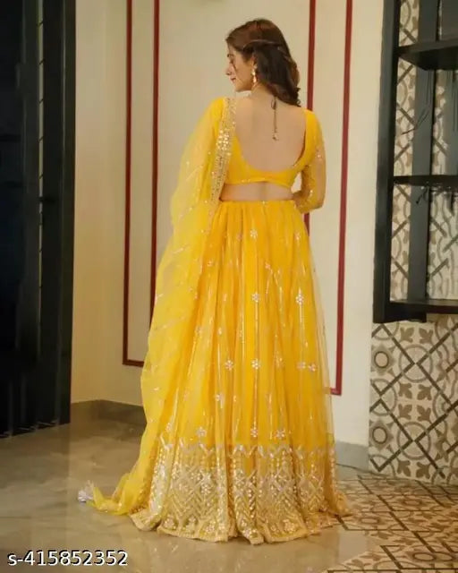 Yellow traditional net embroidery Lehenga Choli for festive wedding functions, intricately embellished Indian attire