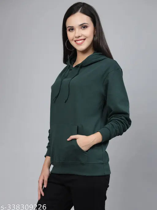 Green cotton oversized sweatshirt with hood by Style Quotient, full sleeves and relaxed fit. Ideal for pairing with denim pants and decent shoes. Made in India