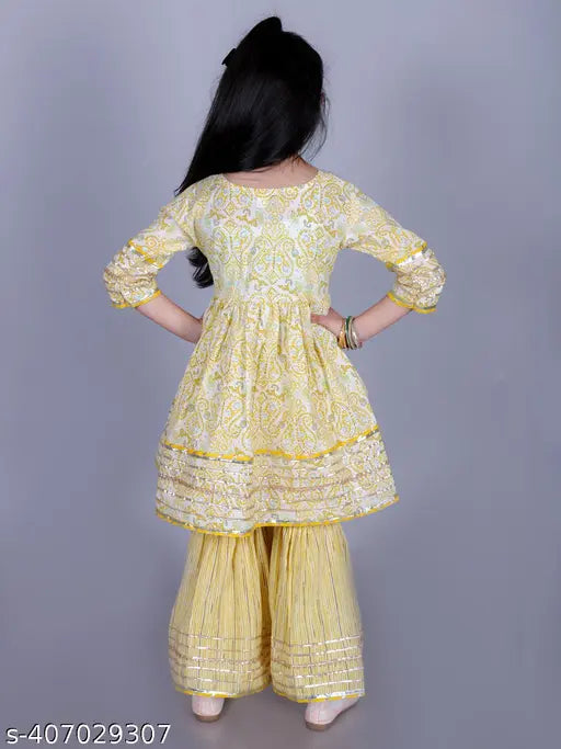 Yellow cotton paisley print Anarkali flared kurta & Sharara set for girls, Indian ethnic wear with intricate embellishments and flared silhouette, perfect for special occasions. Sizes: 2-3 years (20"/20"), 2-3 years (22"/22"), 3-4 years (22"/22"), 4-5 years (24"/24"), 5-6 years (26"/26"), 6-7 years (30"/30"), 7-8 years (30"/30"), 9-10 years (32"/32")