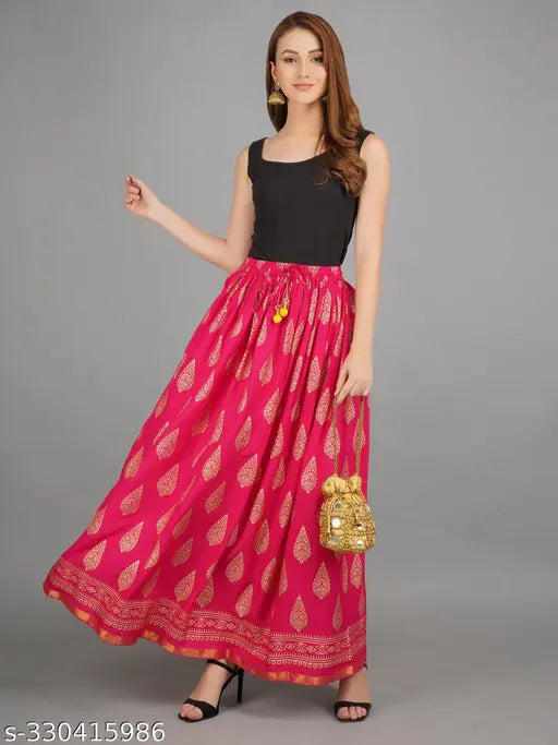 Pink rayon flared maxi skirt with gold print, elastic waistband, free size available. Traditional Rajasthani ethnic design, suitable for casual and Indian festive wear