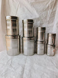 Stainless steel vertical canister set of 8pcs, featuring 350ML, 500ML, 700ML, 900ML, 1.25Ltr, 1.6Ltr, 2.2Ltr, 2.9Ltr in silver, ideal for food storage and pantry organization