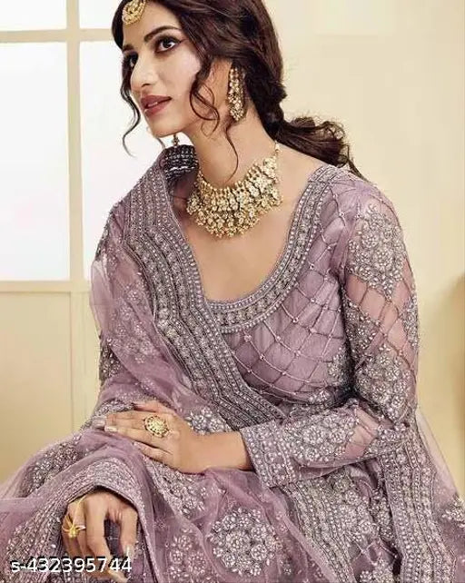 Stylish net lehenga choli with dupatta, featuring diamond embroidery. Delicate net fabric and embellishments for an elegant, Indian ensemble. Semi-stitched (waist 42in, length 42in, dupatta 70in)