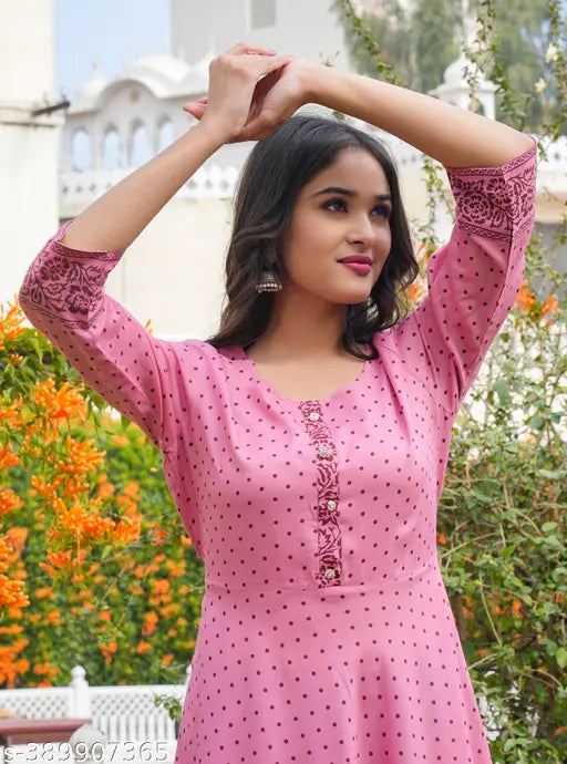 Women's rayon polka dot printed flared kurti with three-quarter sleeves, vibrant print on a traditional Indian outfit
