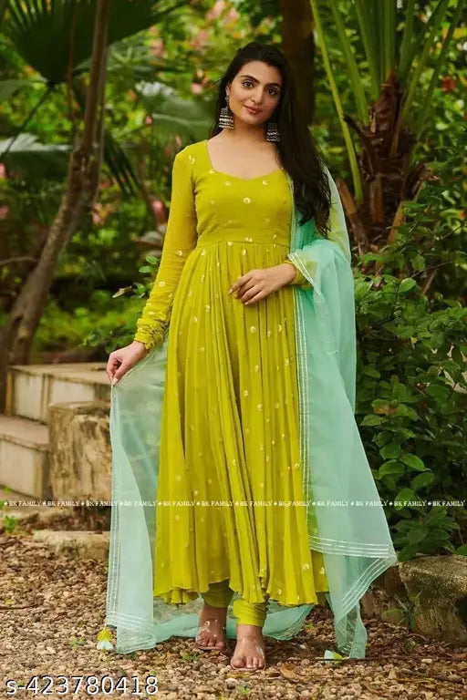 Green georgette embroidered work gown with dupatta, three-quarter sleeves, embellished net pattern. Indian handcrafted traditional bridal wear on mannequin