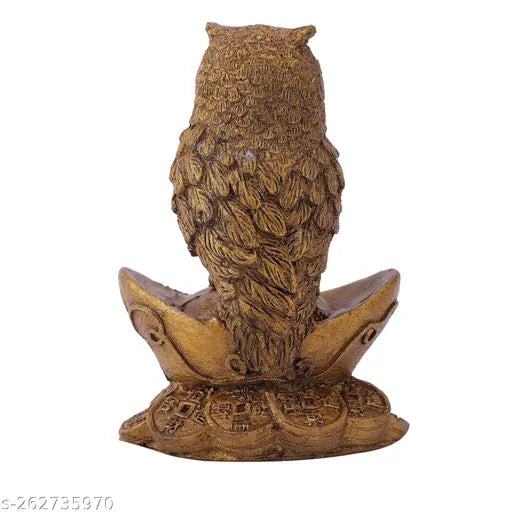 Synthetic resin Vastu owl statue sitting on gold Yuan Bao, symbolizing wealth and prosperity in Indian Feng Shui and Hinduism