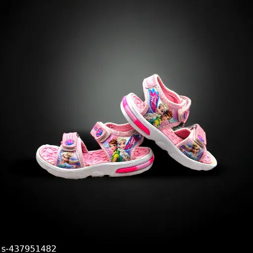 Baby pink patent leather sandals with printed net, ideal for trendy kids aged 2-14 years. Secure velcro fastening and embellishments add style to any outfit. Made in India