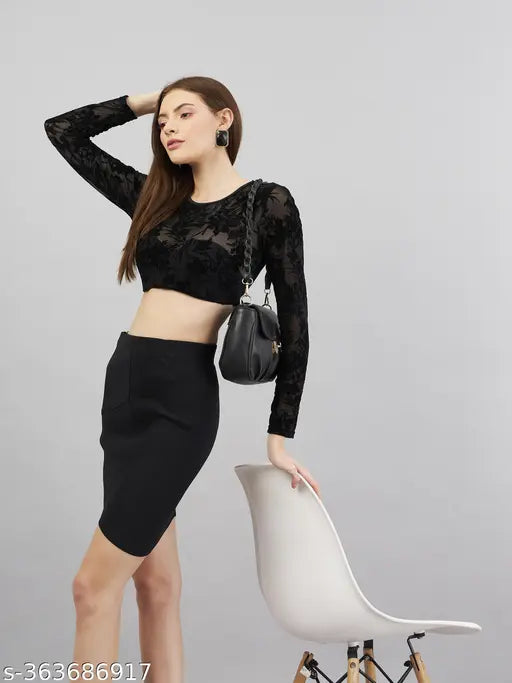 Black polycotton mini pencil skirt for women, stretchable fabric with solid pattern. Close-up of black skirt on hanger, waist size 28, length 21 inches, hip size 32 inches