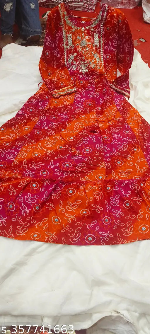 Red rayon bandhani-printed frock-style kurti with three-quarter sleeves, perfect for women's party wear