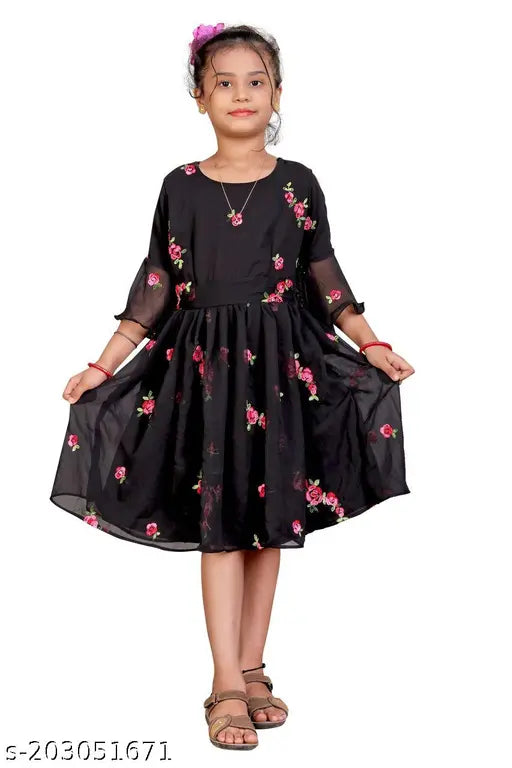 Black Georgette embroidered fit and flared dress, featuring short sleeves and a length of 29-32 inches. Dress can be fitted for bust sizes 26-34 inches and waist sizes 20-28 inches. Made in India with attached inner lining. Dry clean or hand wash
