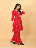 Cotton printed Sharara and Flared kurta set in rayon fabric, wine color, three-quarter sleeves. Indian 2-piece ensemble with foil print work and less patti, available in sizes M-XXL
