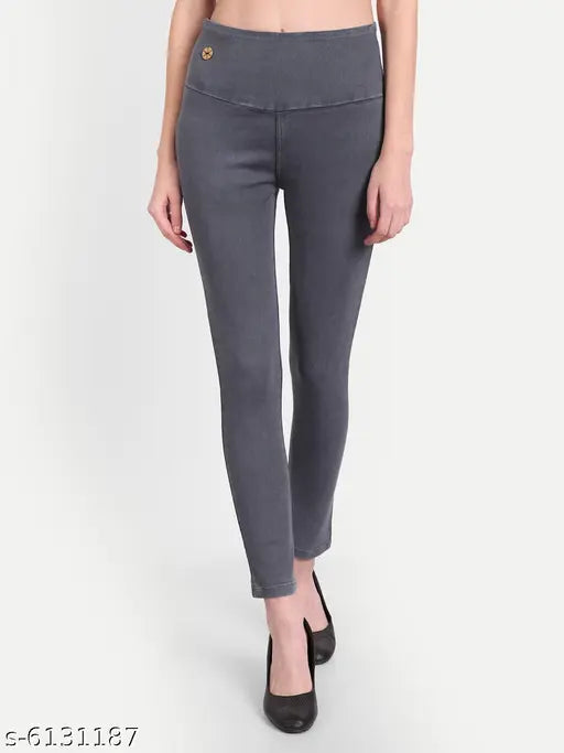 Solid grey denim jeggings with elastic high waist and skinny fit, women's clothing accessory on mannequin