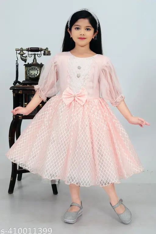 Light peach modal dress for girl, three-quarter sleeves, printed net pattern. Shimmering light pink and green hues, drapes elegantly, crafted in India