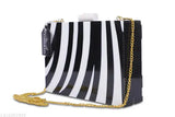 Handmade resin and wood black & white style clutch/sling bag, one compartment, printed net pattern, free size (4" x 3"). Accessorize party wear with this unique, artisanal resin handbag from India