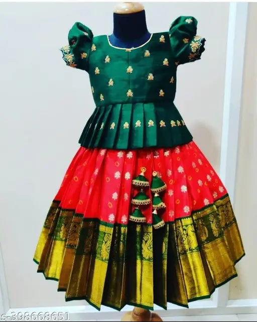 Customized kids silk lehenga choli, vibrant ethnic wear. Embroidered, colorblocked, short-sleeved traditional Indian attire for girls aged 18 months to 12 years. Dry clean only, regular fit, and suitable for various occasions like festivals, weddings, parties, and birthdays. Perfect gift for a special occasion. Made in India