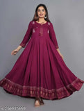 Maroon rayon printed gown, three-quarter sleeves. Woman wearing fashionable Indian maxi dress