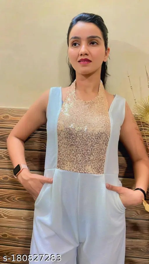 Trendy polyester jumpsuit with sequin embellishments, sleeveless, halter neck, deep v backline, XL size. Indian party wear on mannequin