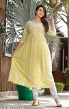 Lemon yellow rayon kurti with floral embroidery, three-quarter sleeves, and printed pattern. Indian women's fashion accessory on mannequin