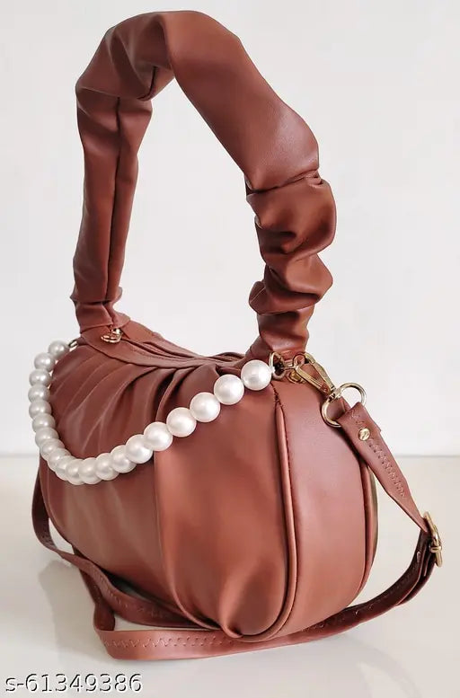 Synthetic coral slingbag with removable strap and handheld handle, perfect for women's daily essentials. Soft leather material, stylish design, and 3L capacity