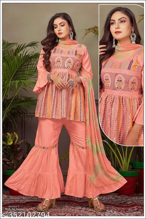 Pink rayon embroidered kurti set with sharara and dupatta, featuring three-quarter sleeves. Affordable women's partywear, perfect for any occasion. Made in India
