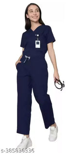 Navy blue nylon scrub suit with short sleeves, featuring multiple pockets and drawstring pants with elastic waistband. Durable and wrinkle-resistant, ideal for healthcare professionals