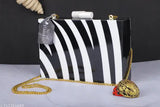 Handmade resin and wood black-and-white style clutch/sling bag with 1 compartment, featuring printed net pattern. Perfect for party wear accessories." (123 characters)