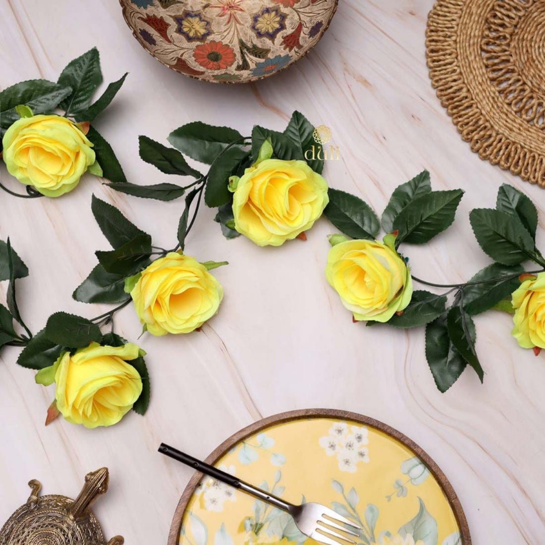 Artificial yellow silk-polyester rose vine with green leaves for home party decoration, ideal for living room, garden, or outdoor use. Perfect gift for loved ones on special occasions like Valentine's Day