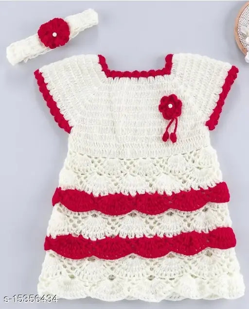 White crocheted dress with red edging, small red bow on front