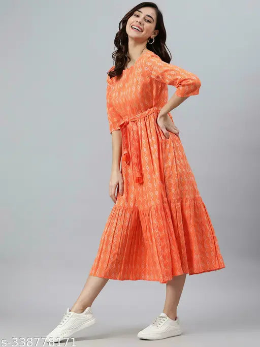 Orange cotton kurti with three-quarter sleeves and printed combo, Taj Trends Jeniffer style. Size options: XS (34 in bust, 44 in length), S (36 in bust, 44 in length), M (38 in bust, 44 in length), L (40 in bust, 44 in length), XL (42 in bust, 44 in length), XXL (44 in bust, 44 in length). Indian-inspired fashion wear