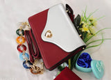 Spacious two-partition sling bag in synthetic leather with a maroon and white pattern